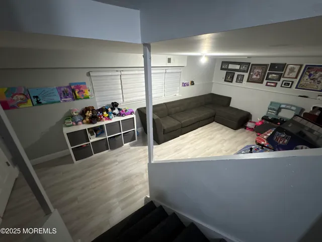 a living room with hard wood flooring and a couch