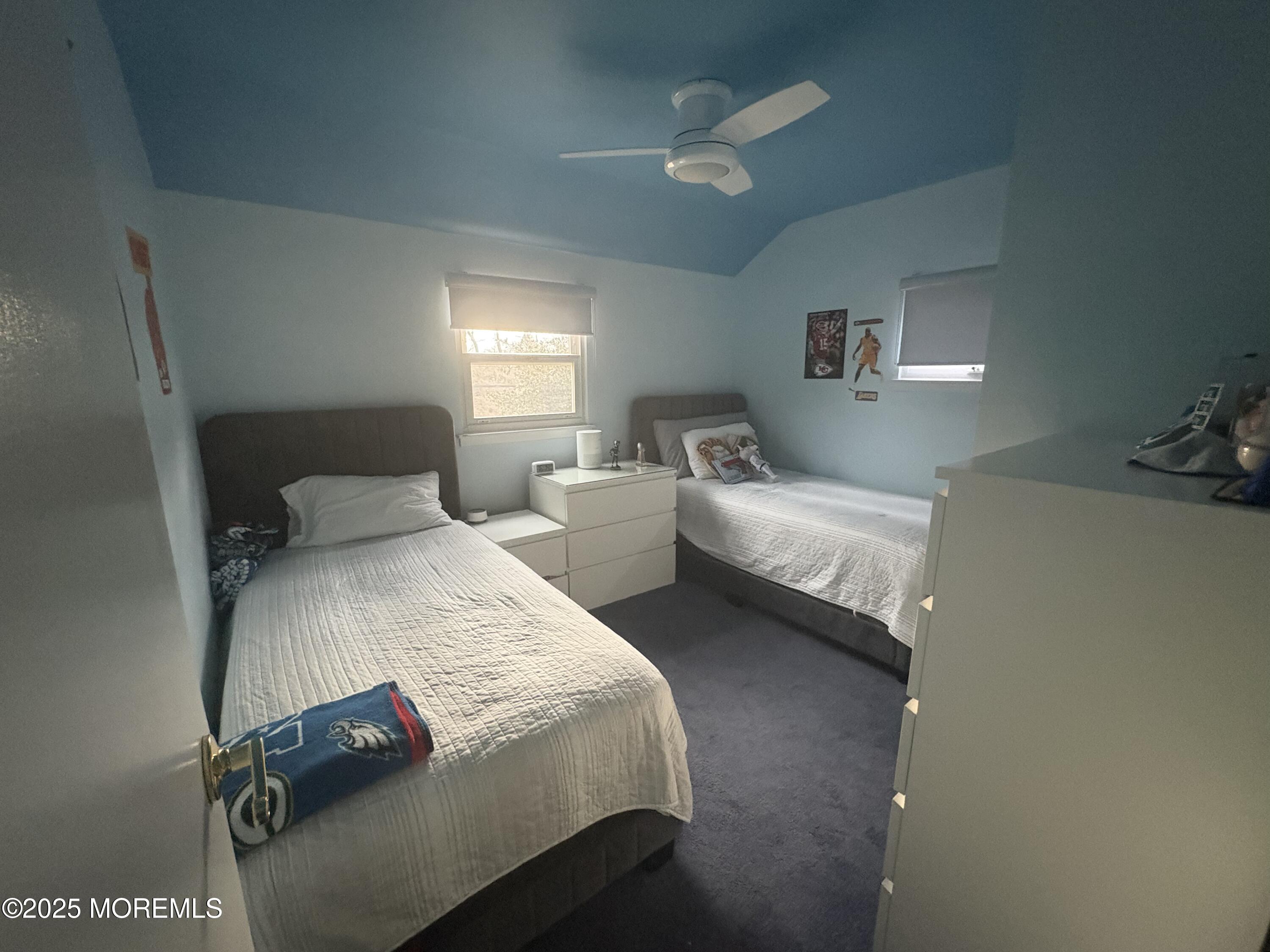 7 Peach Tree Road Oakhurst, NJ 07755 - Photo 18 of 21 a bedroom with two bed and a chandelier