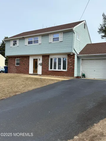 a front view of a house with a road