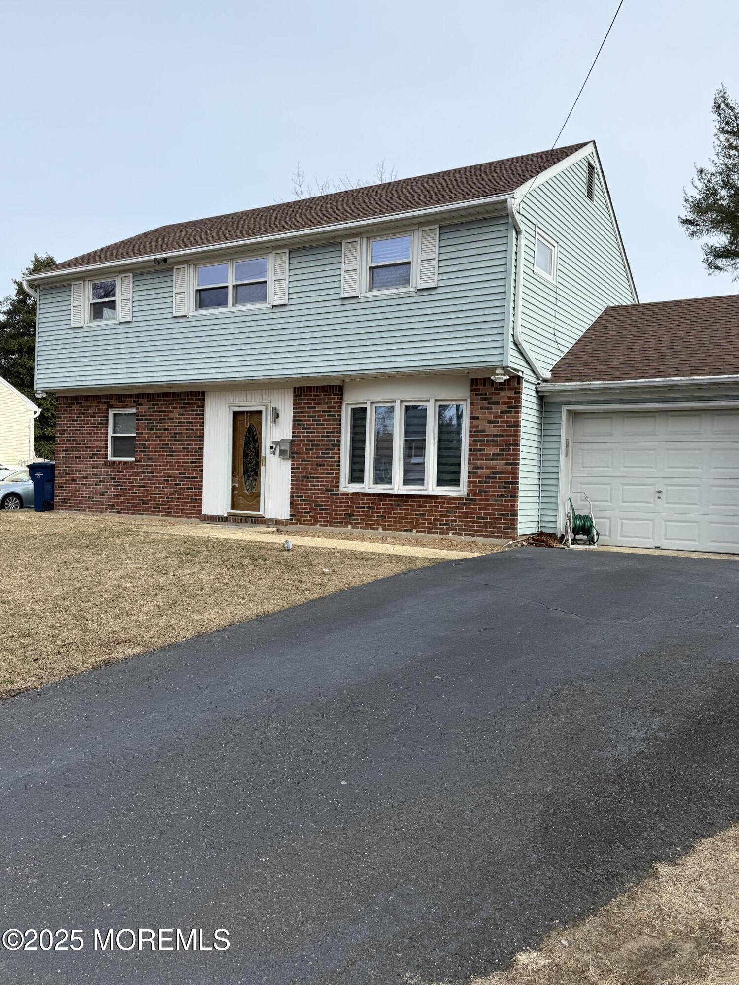 7 Peach Tree Road Oakhurst, NJ 07755 - Photo 2 of 21 a front view of a house with a road