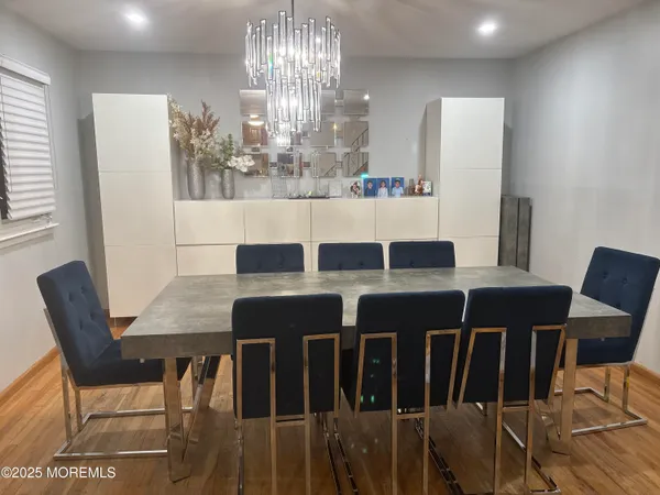 a view of a dining room with furniture and chandelier