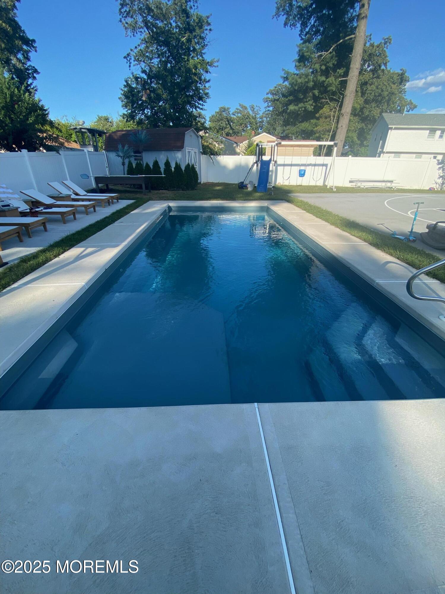 7 Peach Tree Road Oakhurst, NJ 07755 - Photo 6 of 21 a view of a swimming pool with an outdoor space
