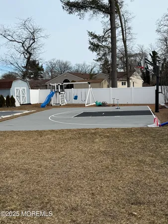 a view of a house with a yard and tree s