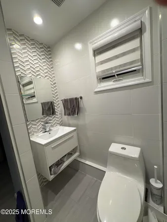 a white toilet sitting next to a bathroom sink