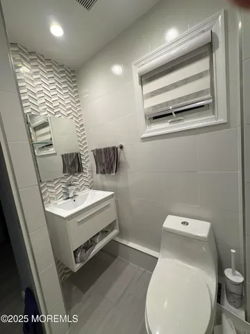 a white toilet sitting next to a bathroom sink