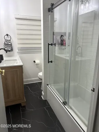 a bathroom with a shower and a toilet