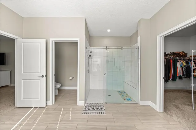 a bathroom with a shower and a mirror