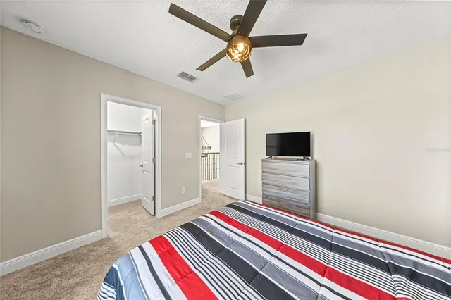 a bedroom with a bed and a television