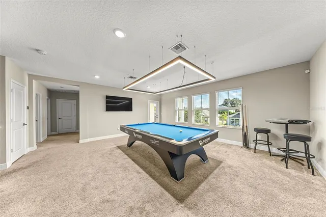 a living room with furniture a flat screen tv and a large window