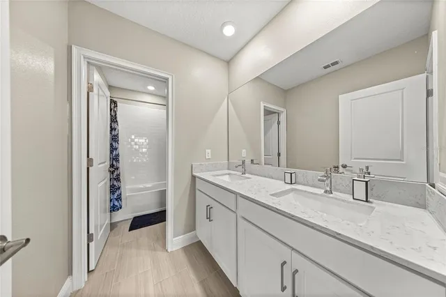 a spacious bathroom with a granite countertop sink mirror and double