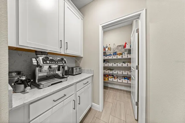 a kitchen with white cabinets and a sink