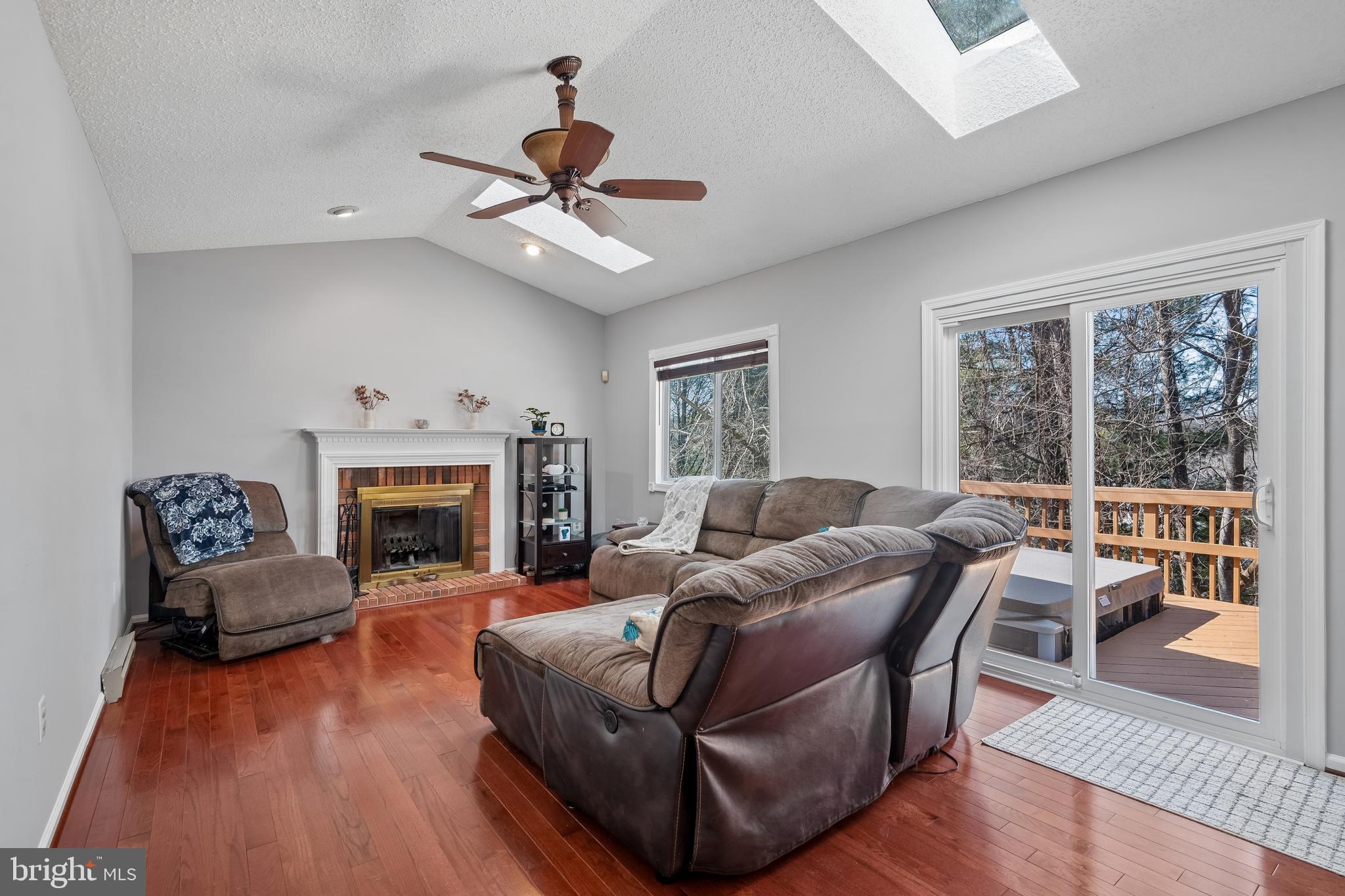 13525 Winding Trail Court Silver Spring, MD 20906 - Photo 14 of 40 a living room with furniture a fireplace and a floor to ceiling window