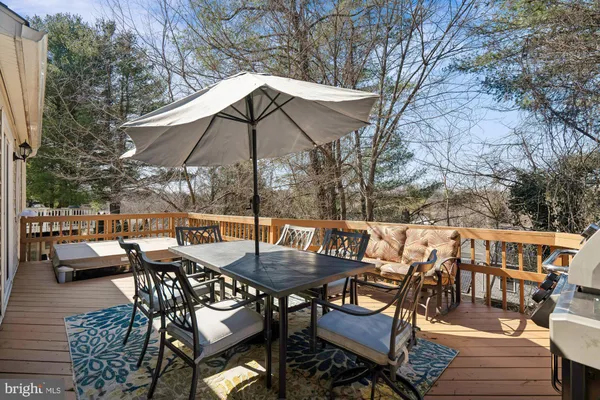 a view of a workspace with furniture and wooden floor