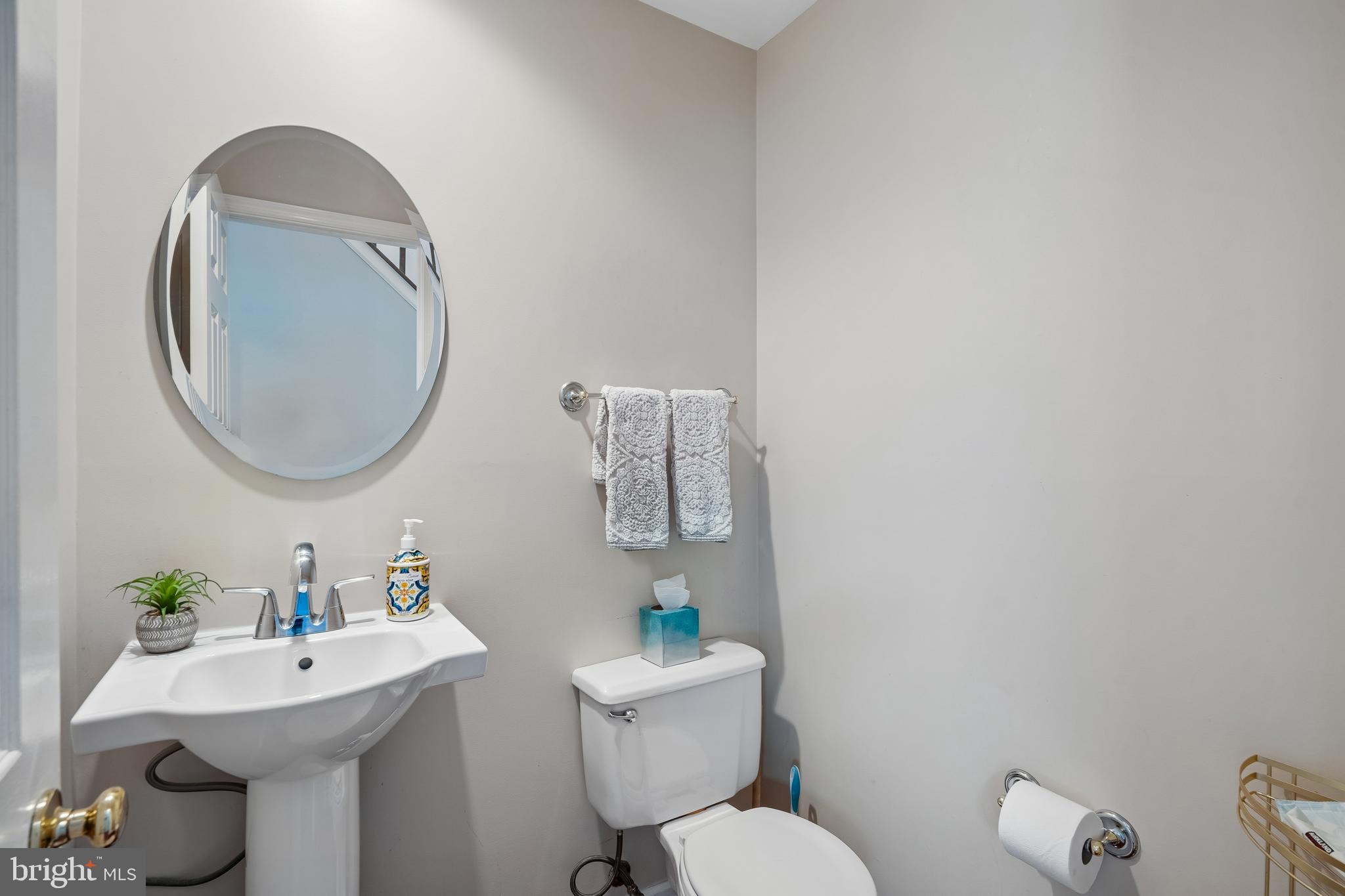 13525 Winding Trail Court Silver Spring, MD 20906 - Photo 19 of 40 a bathroom with a toilet a sink and mirror