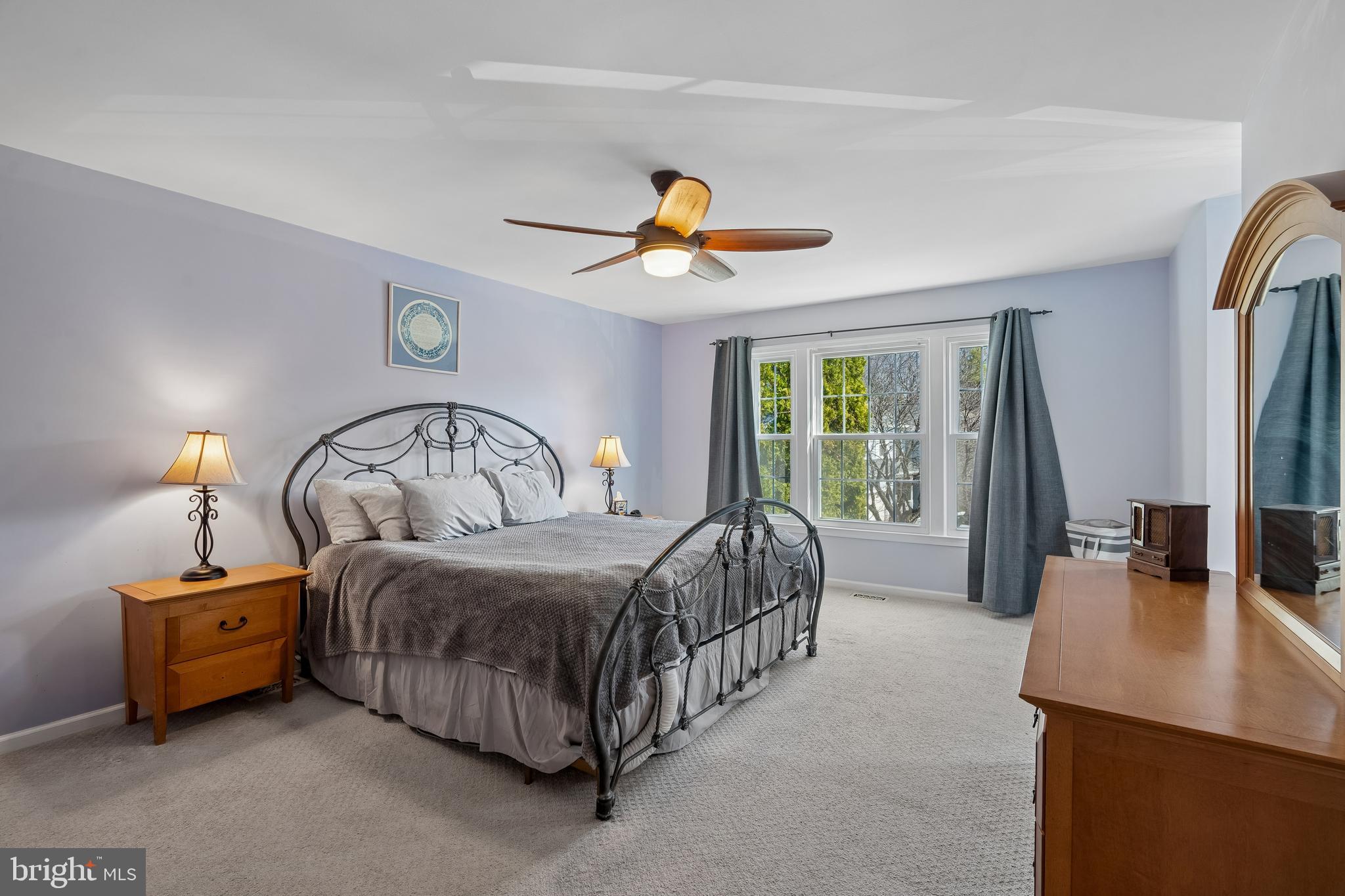 13525 Winding Trail Court Silver Spring, MD 20906 - Photo 20 of 40 a bedroom with a bed a chandelier and a mirror on the dresser