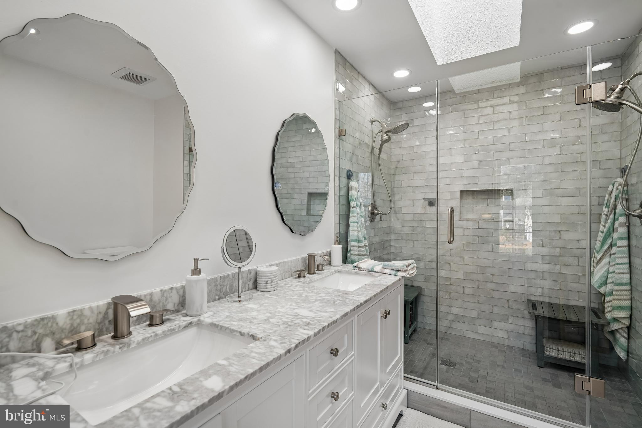 13525 Winding Trail Court Silver Spring, MD 20906 - Photo 22 of 40 a bathroom with a double vanity sink mirror and shower
