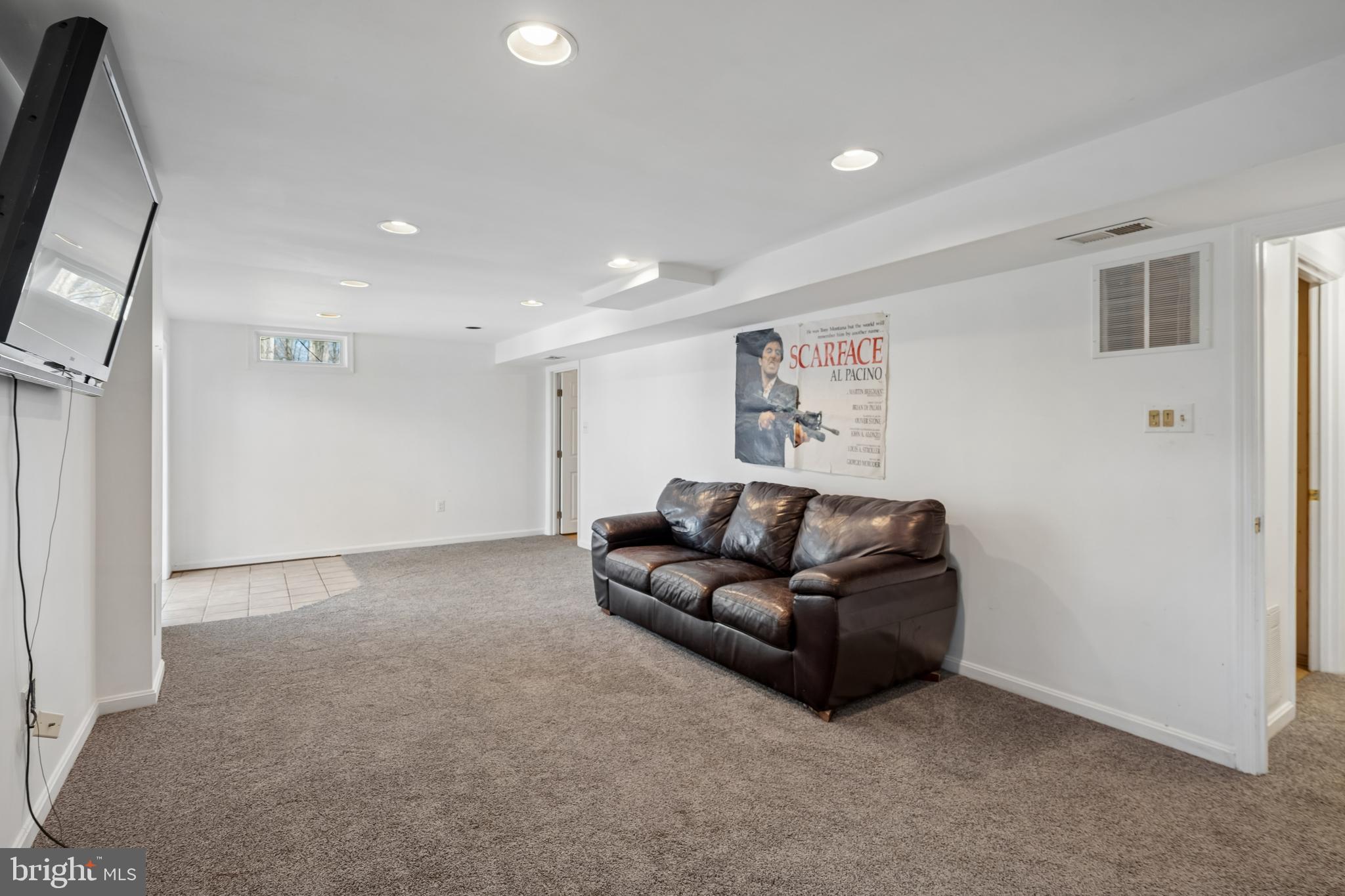 13525 Winding Trail Court Silver Spring, MD 20906 - Photo 33 of 40 a living room with furniture and a flat screen tv