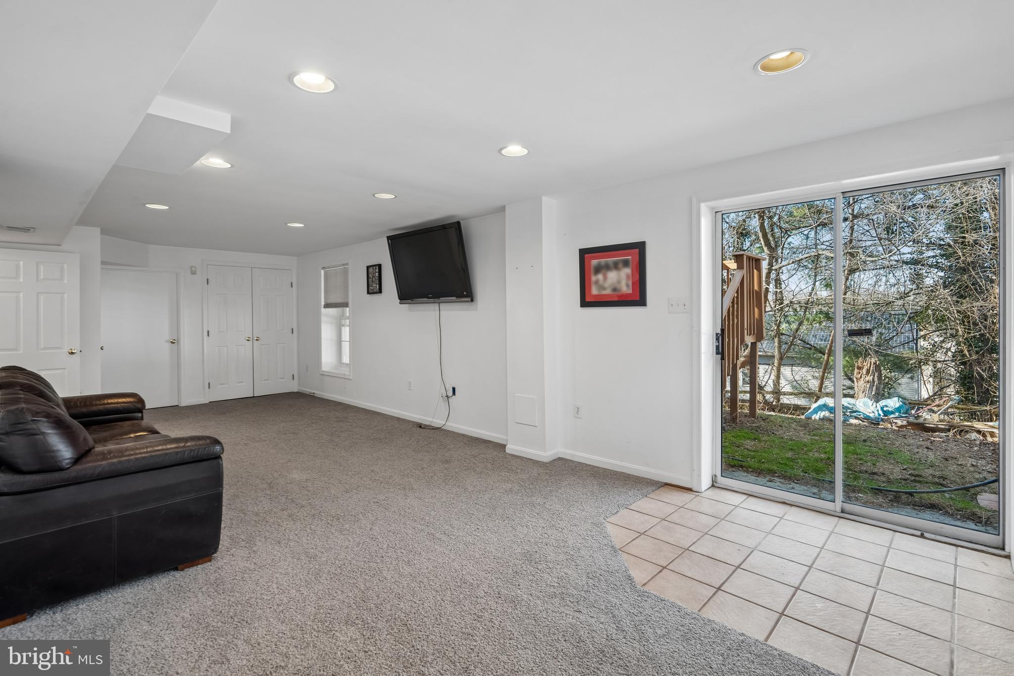 13525 Winding Trail Court Silver Spring, MD 20906 - Photo 34 of 40 a living room with furniture and a flat screen tv