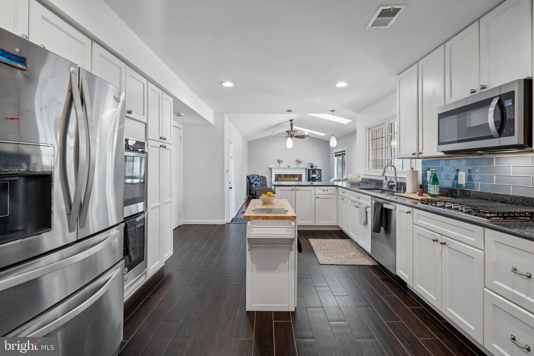 13525 Winding Trail Court Silver Spring, MD 20906 - Photo 10 of 40 a kitchen with stainless steel appliances granite countertop a refrigerator stove microwave and sink