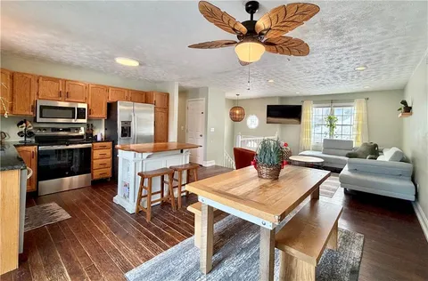 a view of a dining room with furniture a chandelier and wooden floor