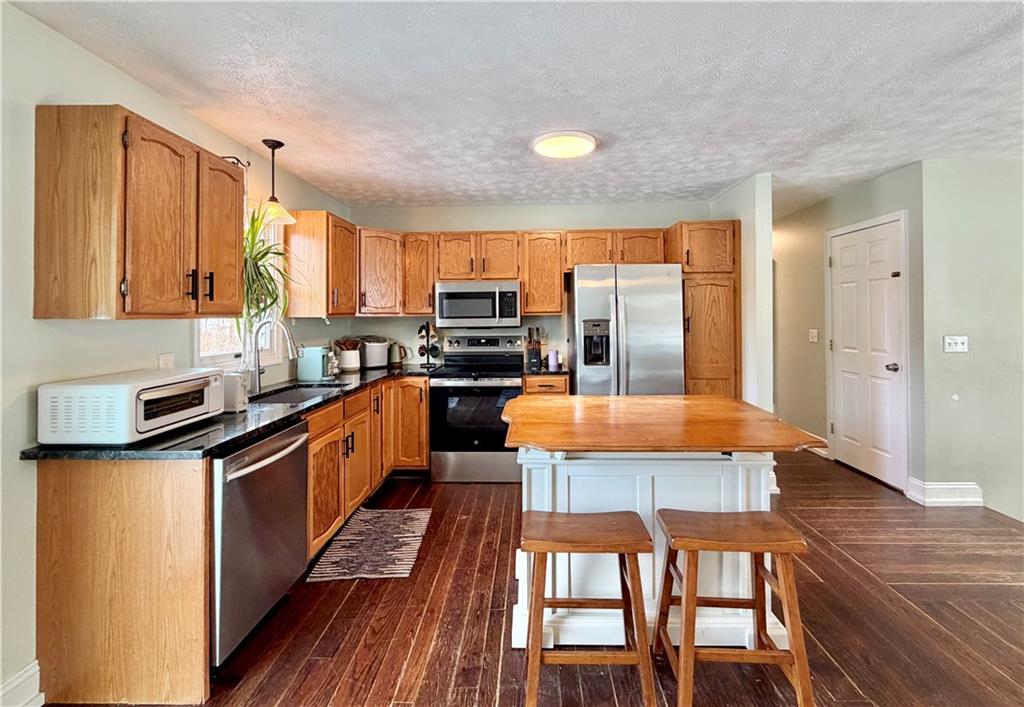 110 West McQuistion Road Butler, PA 16001 - Photo 7 of 32 a large kitchen with stainless steel appliances granite countertop a stove a sink and a refrigerator