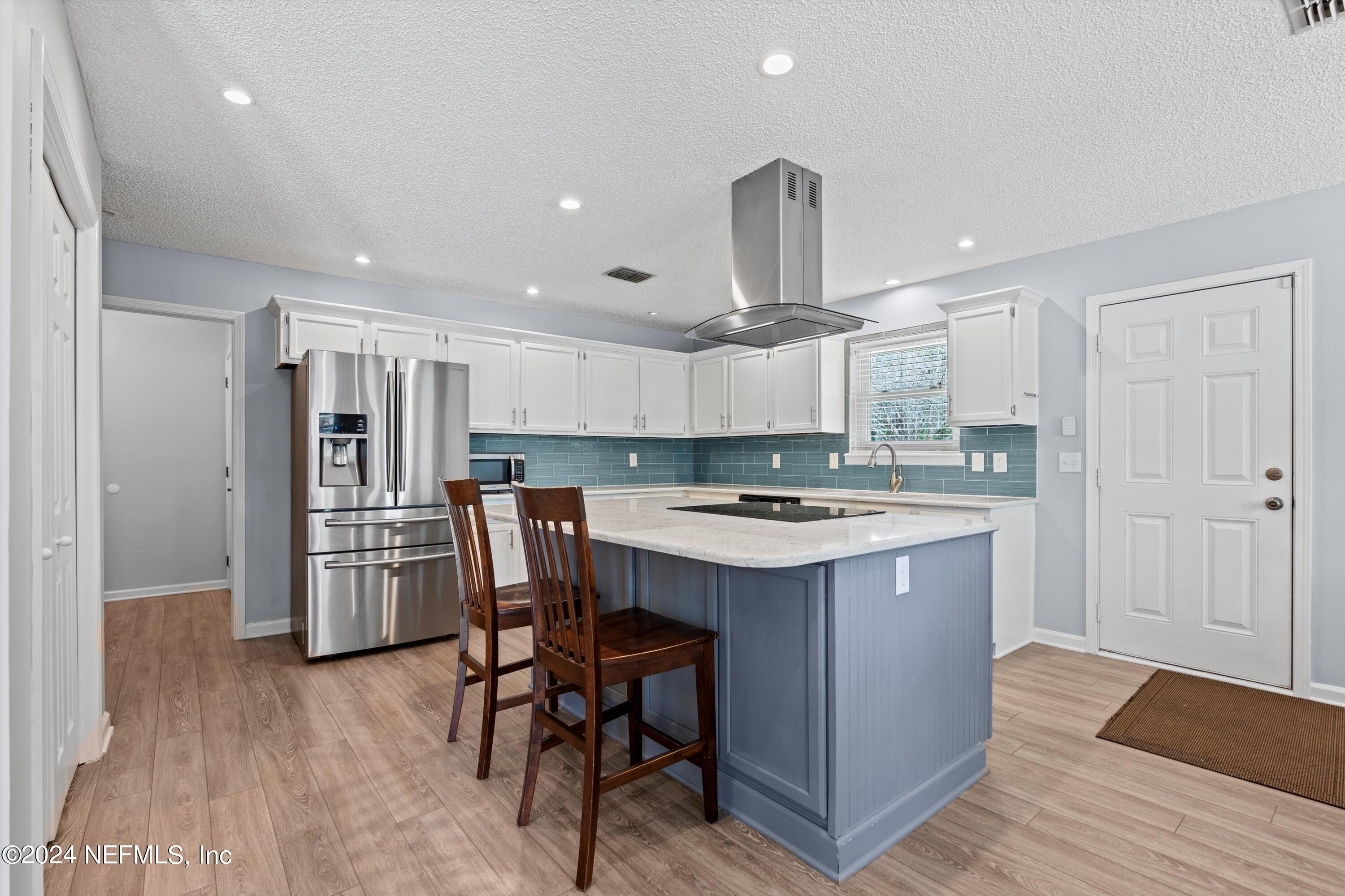 1474 Fruit Cove Forest Road North St. Johns, FL 32259 - Photo 14 of 36 a kitchen with stainless steel appliances a dining table chairs stove refrigerator and cabinets