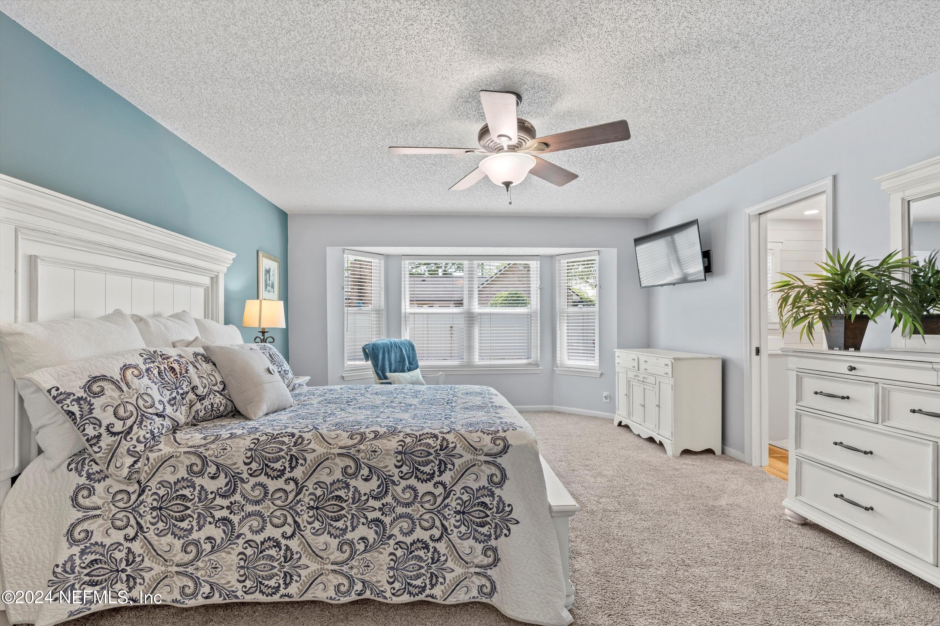 1474 Fruit Cove Forest Road North St. Johns, FL 32259 - Photo 17 of 36 a bedroom with a large bed and furniture