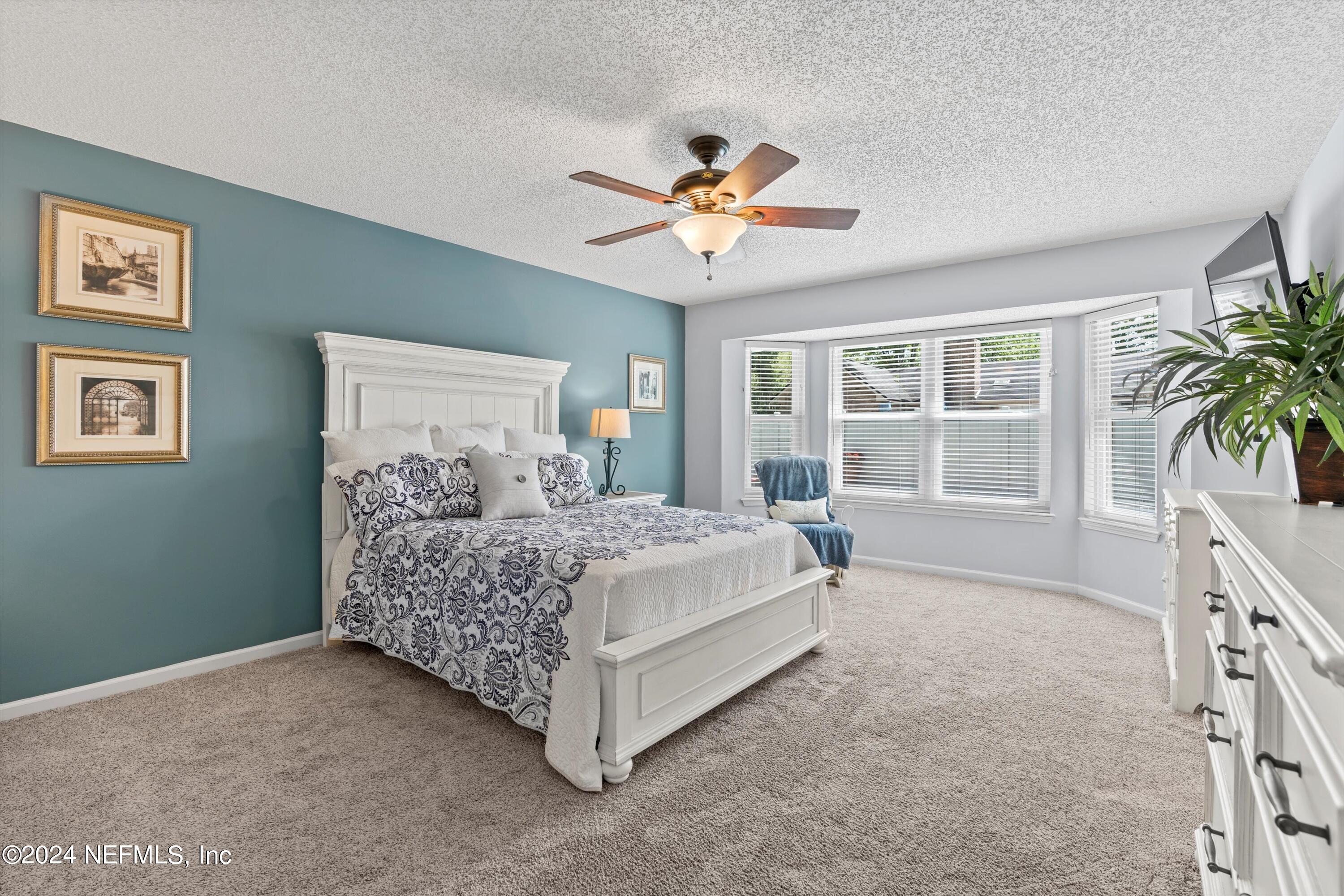1474 Fruit Cove Forest Road North St. Johns, FL 32259 - Photo 18 of 36 a bedroom with a bed dresser and a window