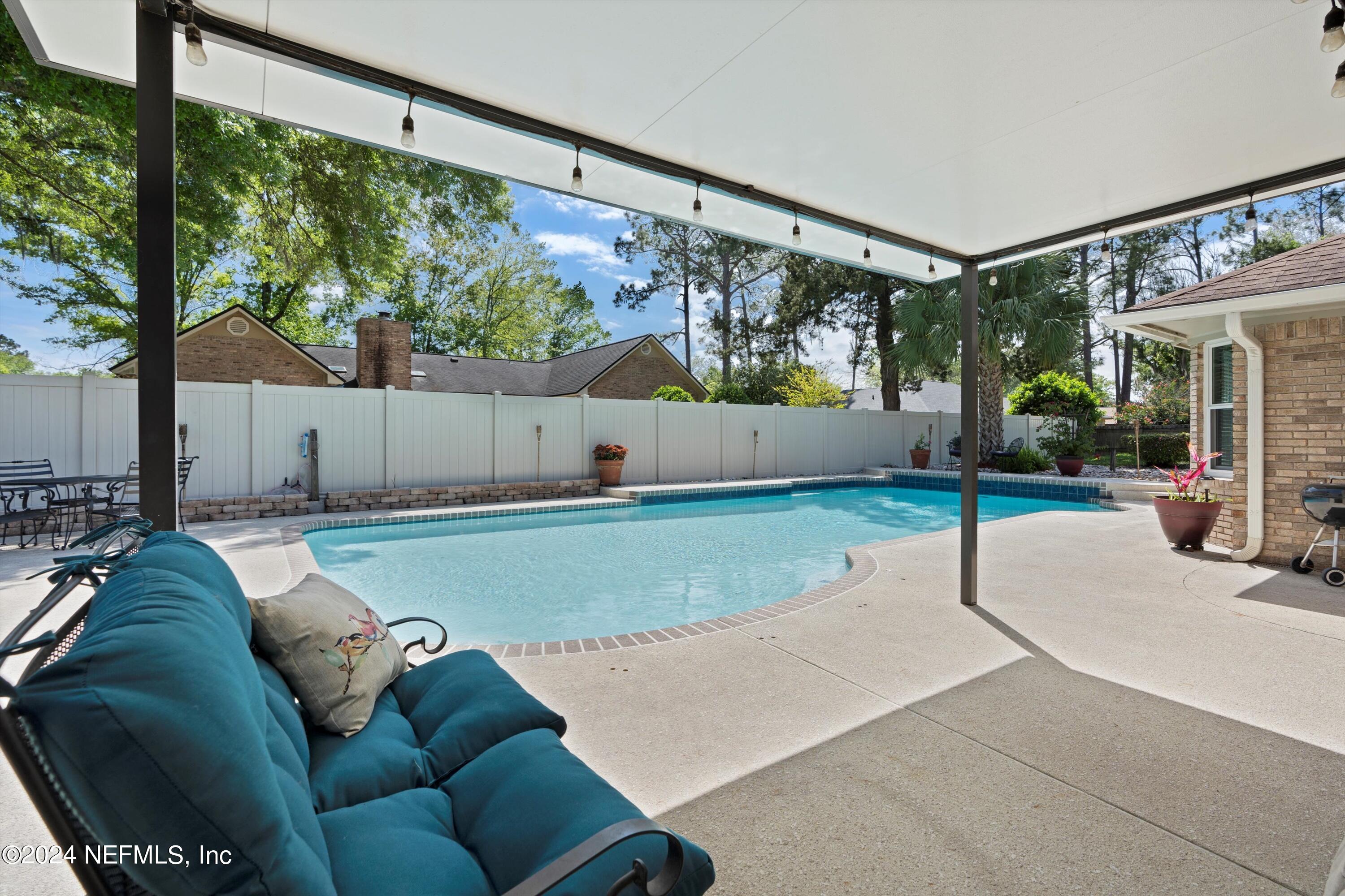 1474 Fruit Cove Forest Road North St. Johns, FL 32259 - Photo 28 of 36 a backyard of a house with table and chairs potted plants with large tree