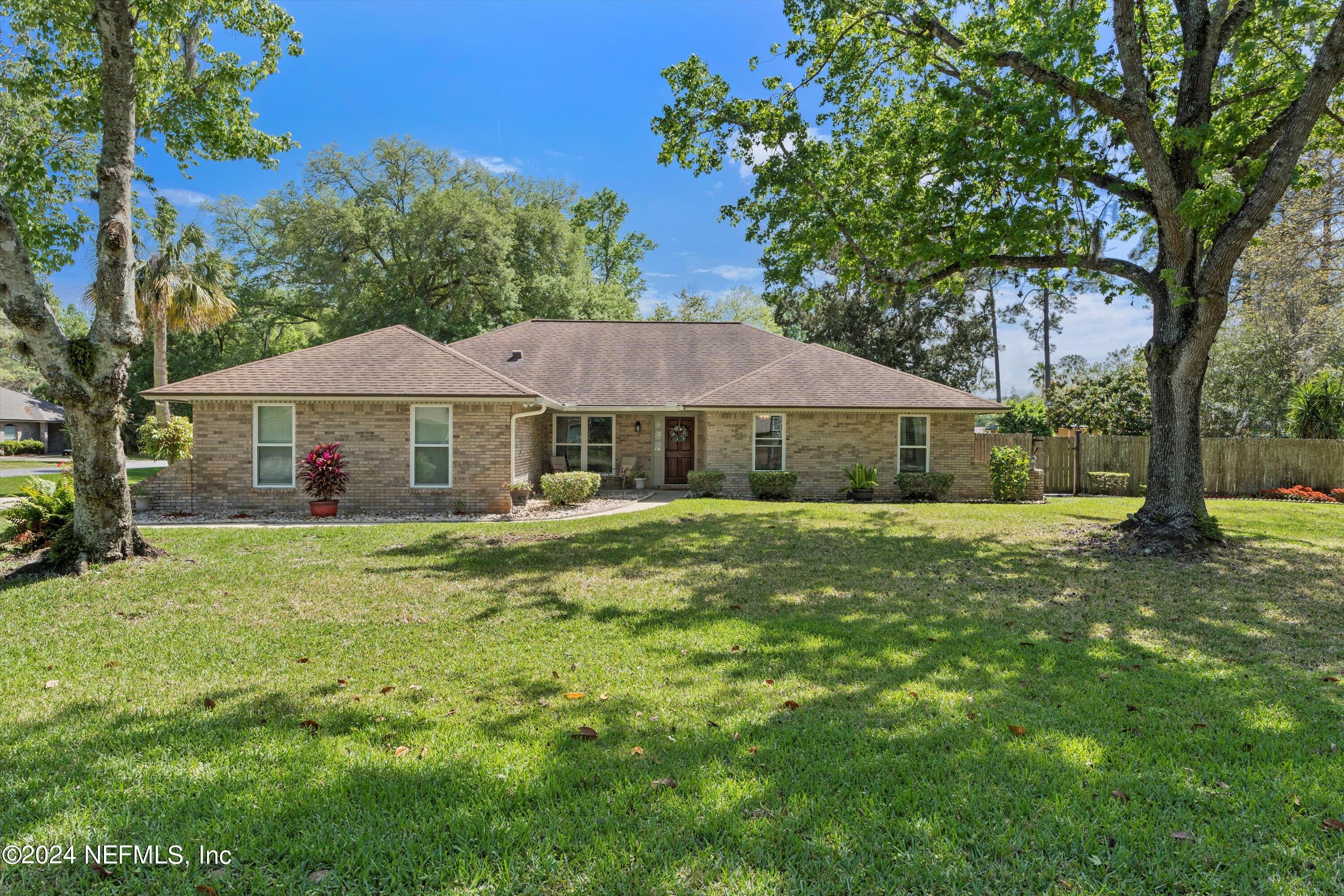 1474 Fruit Cove Forest Road North St. Johns, FL 32259 - Photo 5 of 36 a front view of a house with a yard
