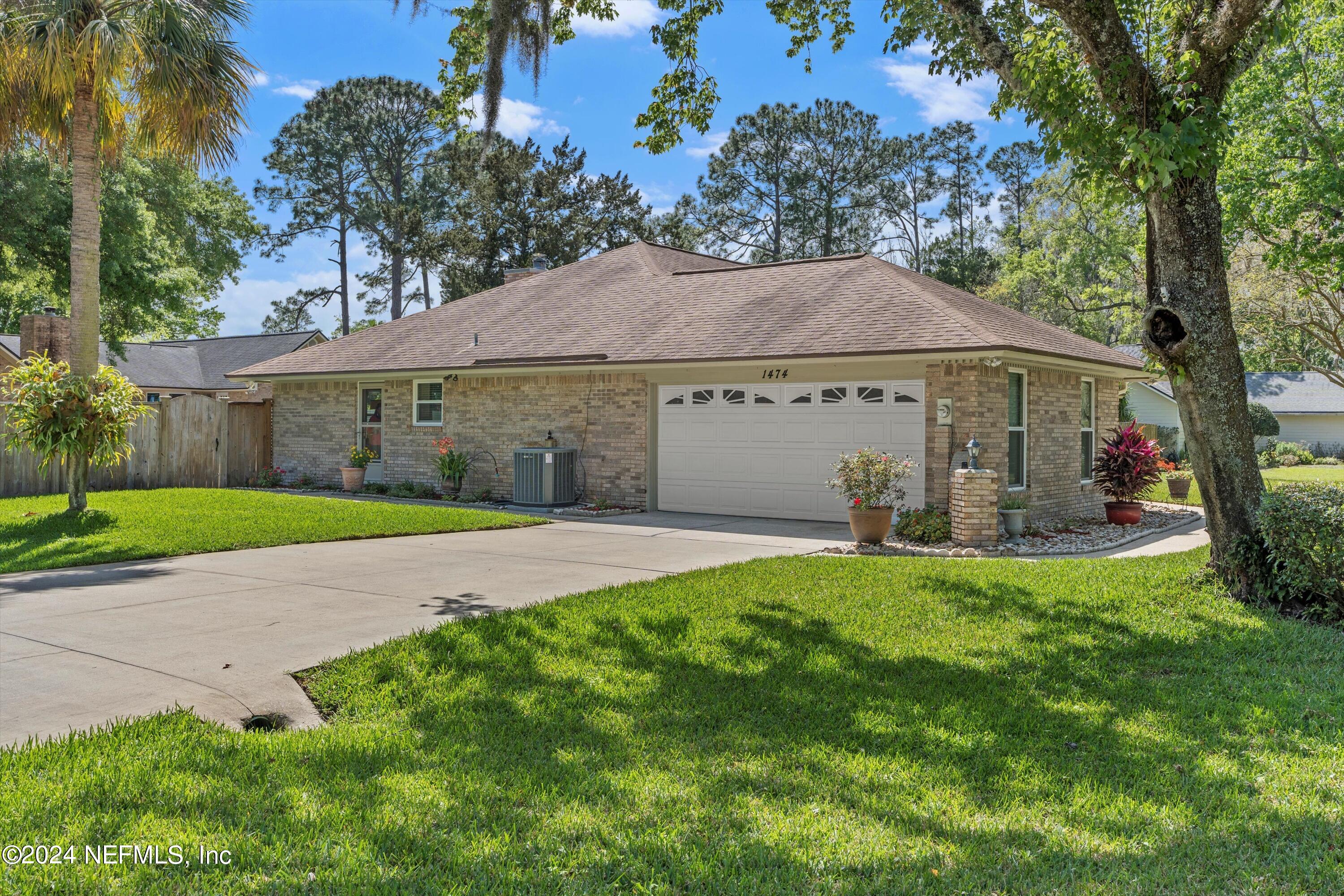 1474 Fruit Cove Forest Road North St. Johns, FL 32259 - Photo 6 of 36 a view of a white house with a big yard plants and large trees