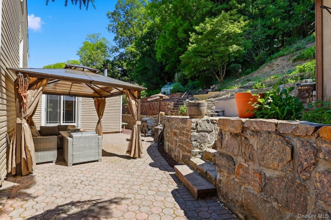 29 Montrose Road Yonkers, NY 10710 - Photo 26 of 39 Expansive paver patio featuring a permanent gazebo structure with a hardtop roof and drapes