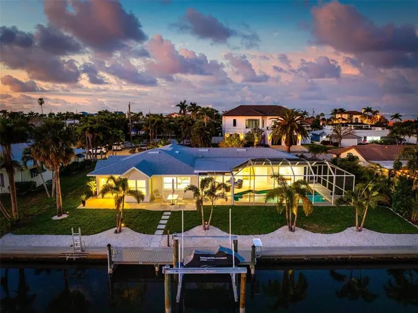 a lake view with boat and palm trees
