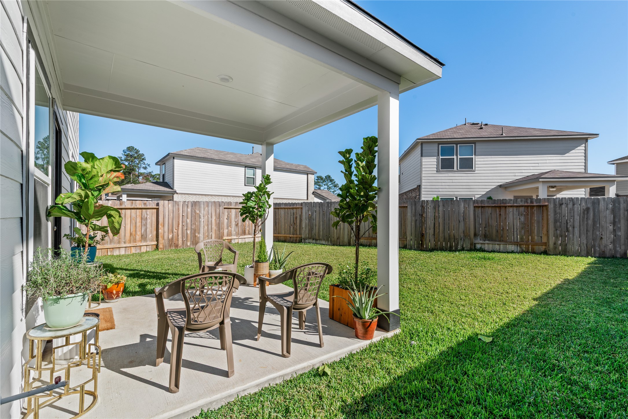 123 Alset Circle Magnolia, TX 77354 - Photo 25 of 27 a view of a chair and table in backyard of the house