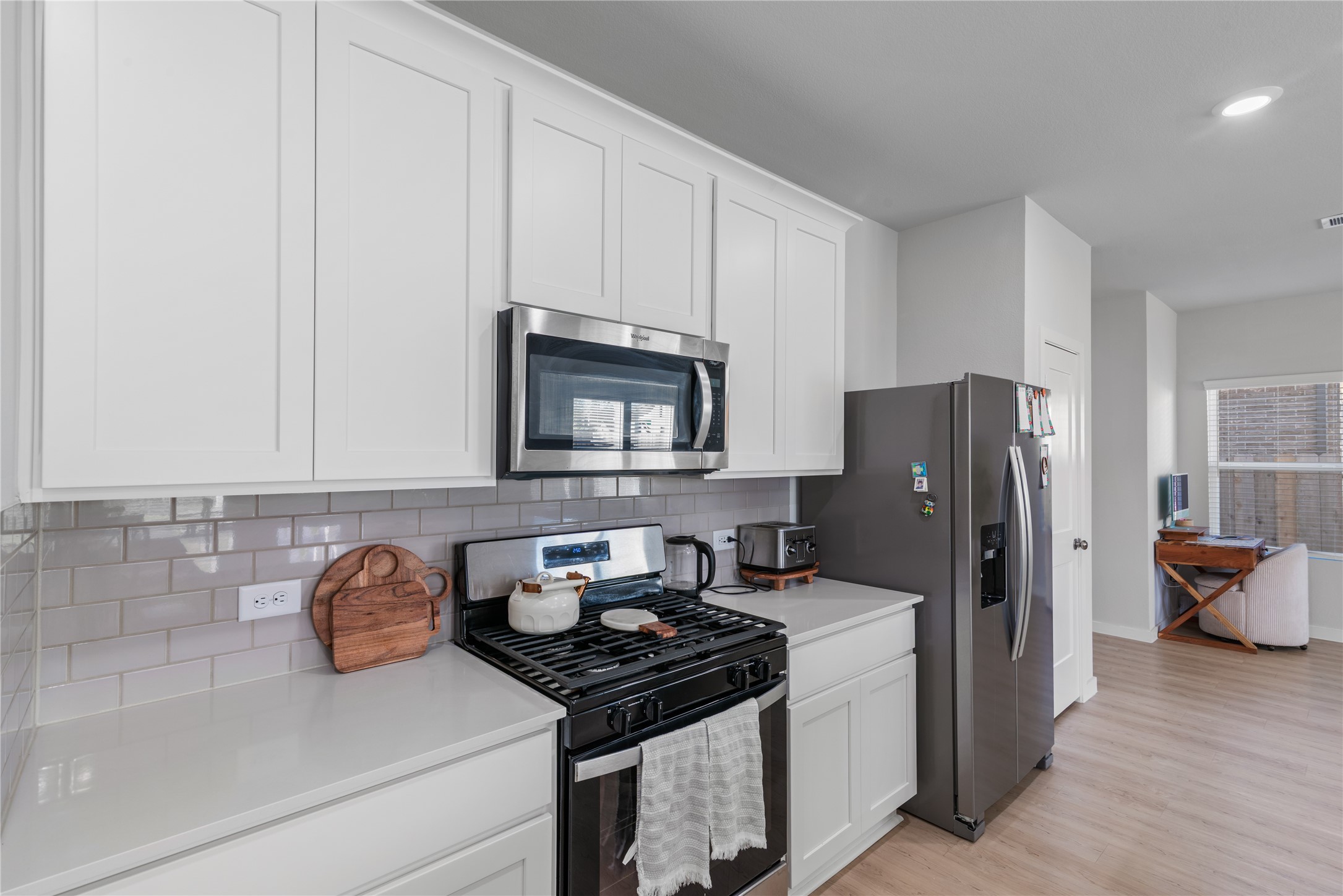 123 Alset Circle Magnolia, TX 77354 - Photo 7 of 27 a kitchen with stainless steel appliances granite countertop a refrigerator stove and sink