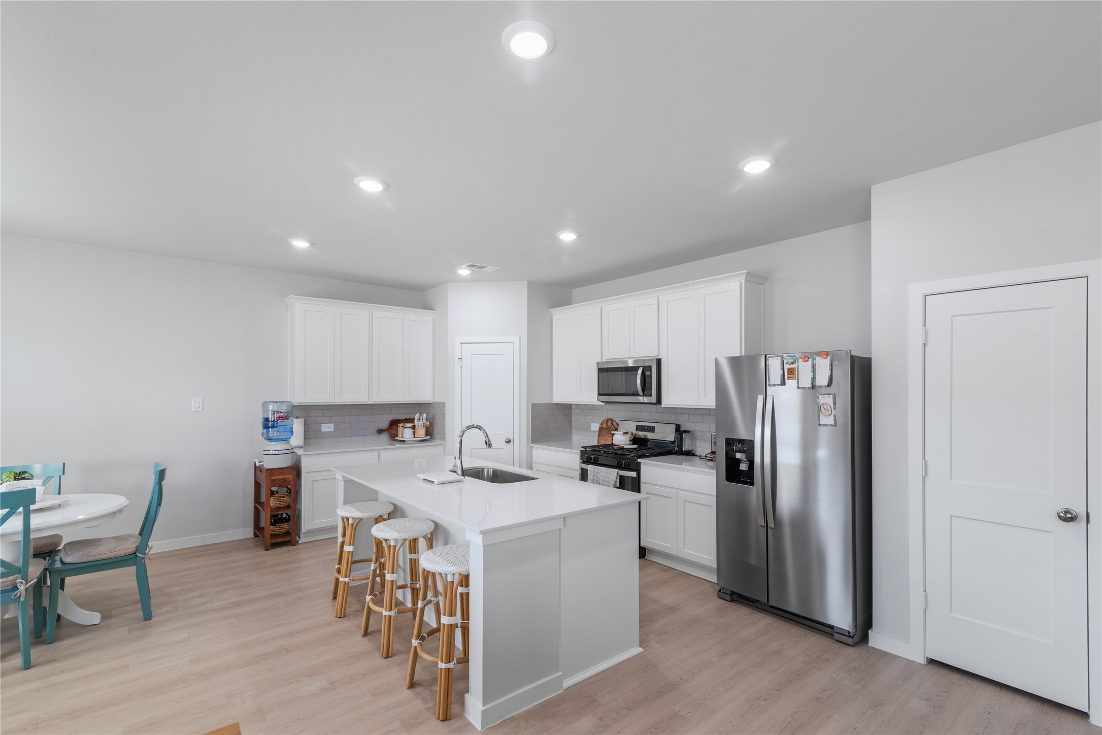 123 Alset Circle Magnolia, TX 77354 - Photo 8 of 27 a kitchen with a refrigerator and a stove top oven