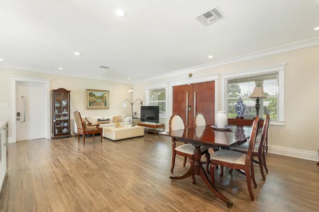 a view of a dining room with furniture and wooden floor