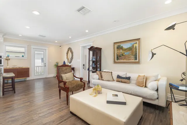 a living room with furniture and wooden floor