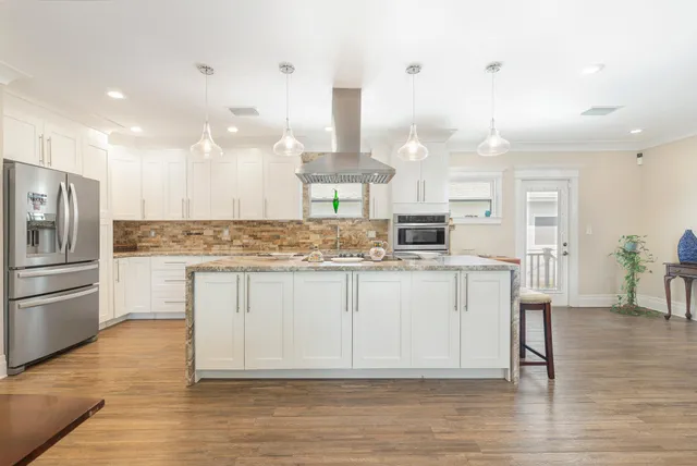 a kitchen with a white cabinets and refrigerator