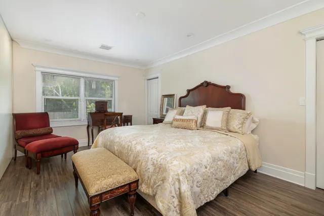 a bedroom with a bed and a chair