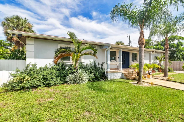a front view of a house with garden and porch