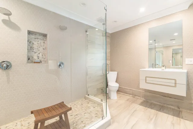 a bathroom with a sink a toilet and shower