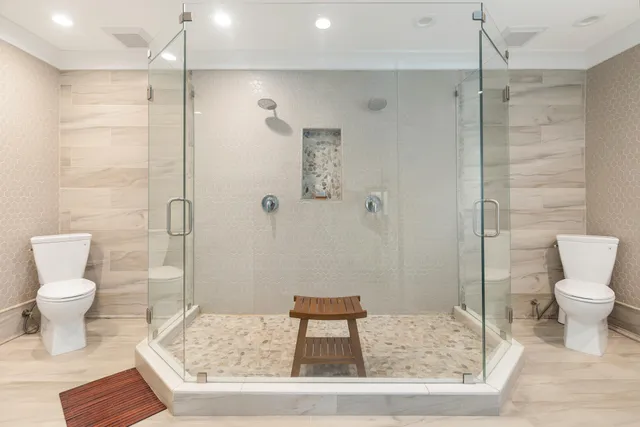 a bathroom with a toilet and a shower