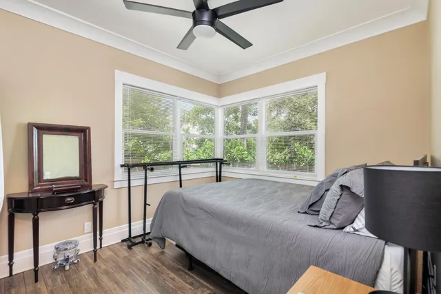 a bedroom with a bed window and a flat tv screen