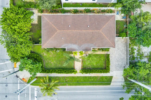 an aerial view of a house with a yard and a garden