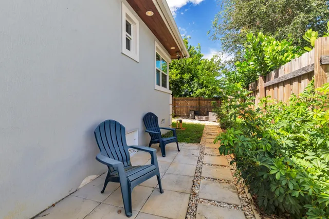 a view of a chairs and table in the backyard