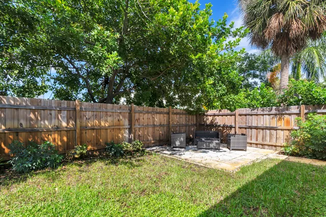 a view of a backyard with a small cabin and a chair