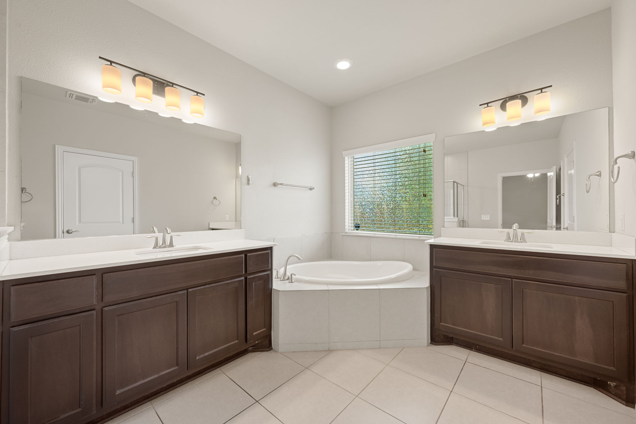 8800 Slater Drive Austin, TX 78747 - Photo 19 of 40 a bathroom with a double vanity sink mirror and bathtub