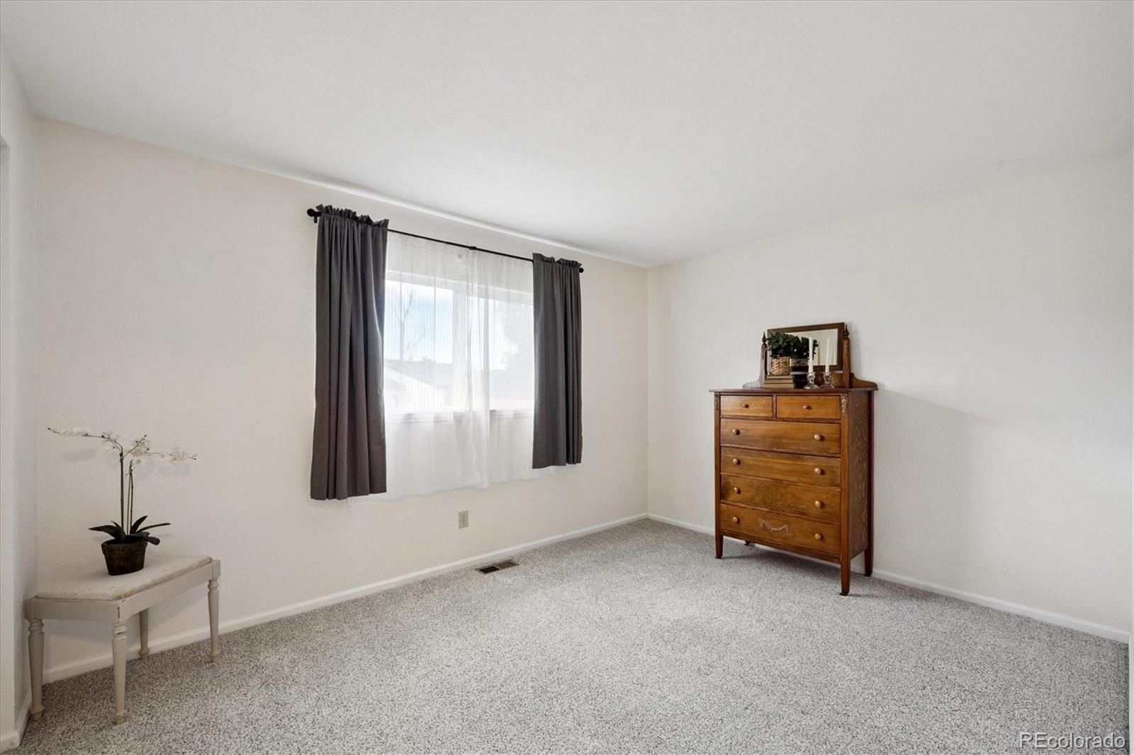704 Madison Way Bennett, CO 80102 - Photo 12 of 29 a view of an empty room with a window