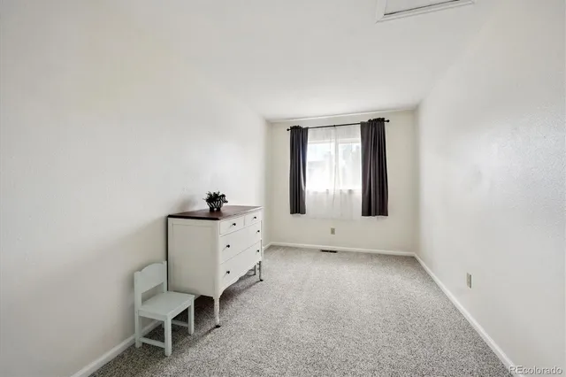 a view of a patio with table and chairs with wooden fence